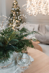 Decorated christmas table in the living room with garlands.