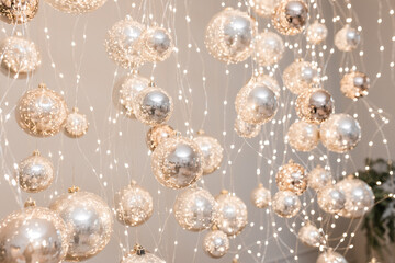 Silver and golden christmas balls with garland with lights. Christmas mood concept for background