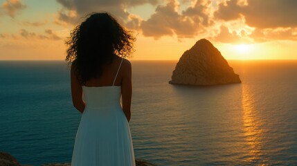A silhouette of a woman in a flowing dress stands peacefully at sunrise overlooking the sea, capturing a moment of reflection, beauty, and connection with nature.
