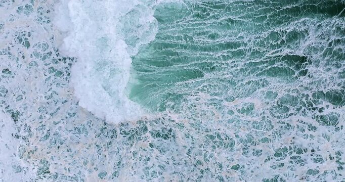 Top-down aerial bird&rsquo;s-eye view of ocean wave patterns and textured Atlantic surf at Nazare, Portugal