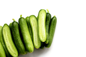 Fresh mini baby cucumbers on white background