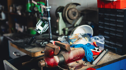 Vintage workshop scene with red metal vise, tools and dusty workbench — retro craftsmanship and DIY atmosphere