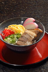Okinawa Soba, a typical Japanese dish with buckwheat noodles, omelet, meat, soy sauce, and hondashi seasoning.