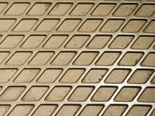 Detailed close-up revealing a textured surface composed of repeating geometric shapes, casting shadows that emphasize its depth and three-dimensionality, ideal for backgrounds and overlays.