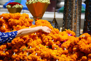 Marigold garlands offered for worship at the Erawan Shrine in Bangkok, Thailand. The heart of Bangkok's spiritual devotion and offerings.