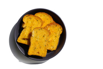 Crispy garlic bread slices on white background.