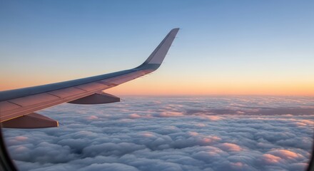Airplane wing and vibrant sunset over cloudscape