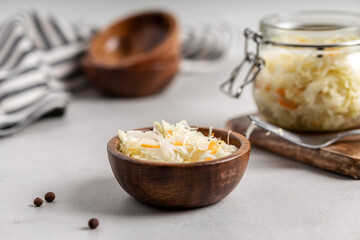 Sauerkraut with carrots in a wooden bowl.