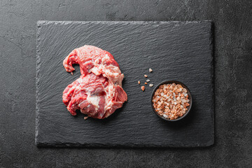 Raw beef meat on a black serving plate