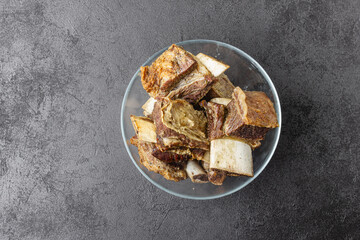 Beef ribs in glass bowl