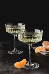 Crystal glasses of champagne with tangerines