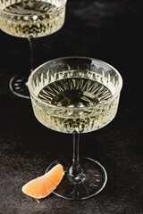 Crystal glasses of champagne with tangerines