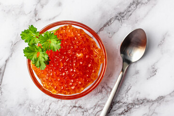 Elegant marble composition with red caviar and herbs