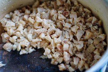 Macro shot showcasing a heap of diced pieces in a container, ideal for illustrating textures, food preparation, or abstract culinary concepts.  Great for illustrating kitchen scenes or savory dishes.