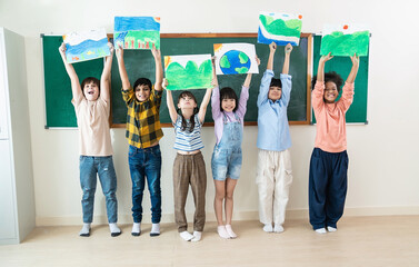 Diverse group of smile children proudly holding up eco-themed drawings in classroom, promote environmental awareness and creativity. World earth day concept