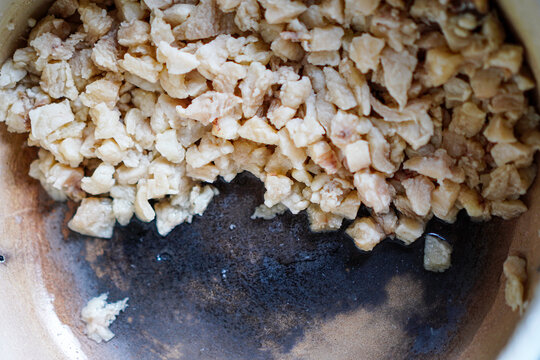A close-up captures the preparation stage of a culinary dish, focusing on cut ingredients filling the bowl. The visual texture and the raw elements present the potential of a meal and preparation.