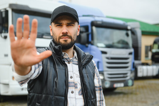 Trucker man showing stop gesture protesting transport logistics