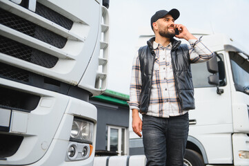 Truck driver talking on phone near lorry transportation