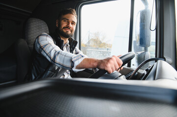 Obraz premium Truck driver smiling driving commercial vehicle