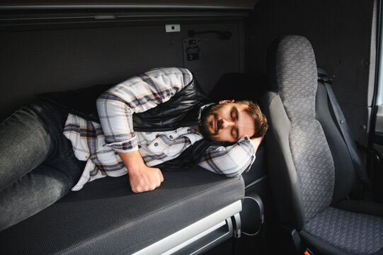 Truck driver sleeping resting inside sleeper cab