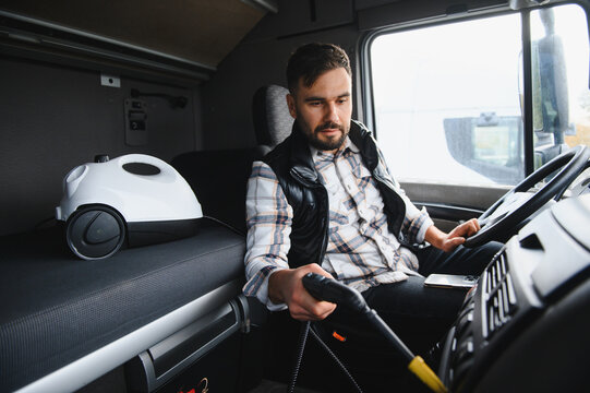 Truck driver cleaning semi truck cabin interior