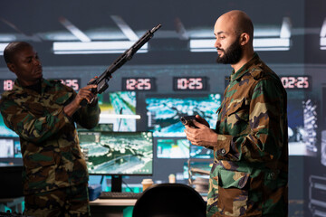 Fototapeta premium Army soldiers checking guns in command post, ensuring ammunition and supplies are properly and evenly distributed. Armed forces units manages combat load before assault operation start