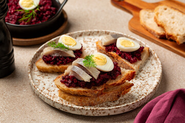 Lunch with Scandinavian open sandwich Smorrebrod with pickled herring, Beet or beetroot, Caviar  and boiled quail egg.