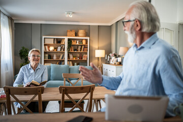 Senior couple sharing happy conversation at home
