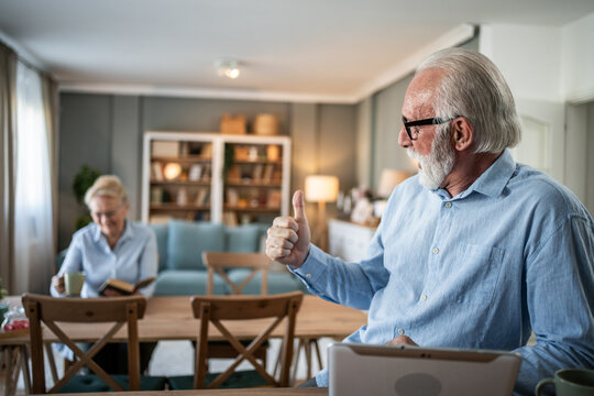 Senior man doing video call, giving thumbs up