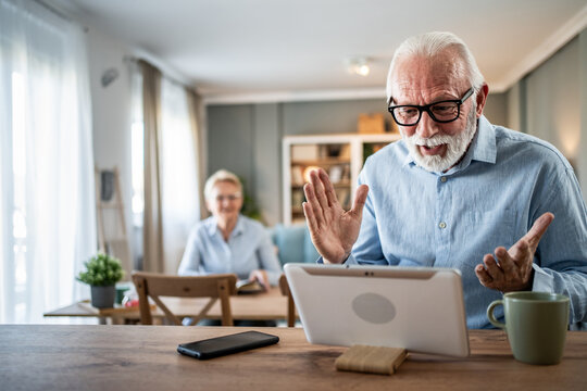 Senior man having video call on tablet at home