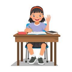 Little girl studying sitting at the desk writing on notebook waving hand