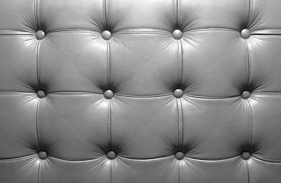 Gray leather upholstery pattern close up. Elegant genuine furniture cover design with buttons. Classic fashion material surface. Soft texture for luxury decor element. Premium quality geometric