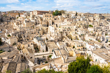 Obraz premium Panoramic view of Matera’s unique limestone dwellings under a bright sky, Apulia, Italy