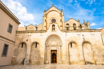 Fototapeta premium Romanesque-style cathedral with arched windows and intricate stone carvings in Matera town, Apulia, Italy