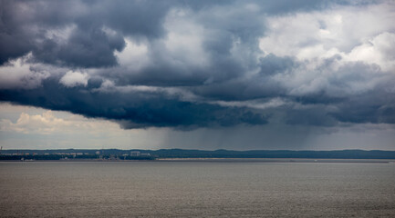 Dark stormy clouds over the sea. Dramatic sky over the sea.