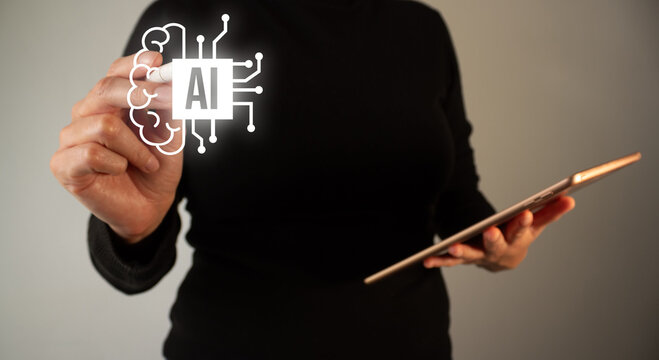 A woman draws a brain with the letters AI and chip connections. Concept of artificial intelligence in our lives