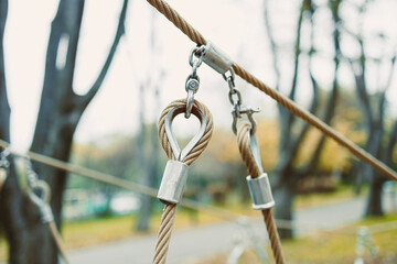 Exploring the intricate details of a climbing recreation area with rope equipment in a vibrant park setting during autumn