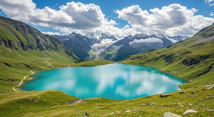 Turquoise alpine lake nestled in a vibrant green valley, surrounded by majestic, snow-capped mountains