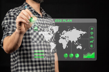 a man holding a digital pen drawing an ESG corporate plan and a corporate sustainability strategy