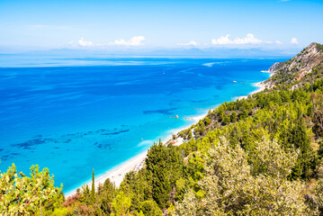 View of pine trees on sea coast and beautiful Avali beach with tuquoise water, Lefkada island, Greece