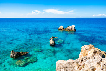 Rocks and stones in crystal clear turquoise sea water of Agios Nikitas bay, Lefkada island, Greece