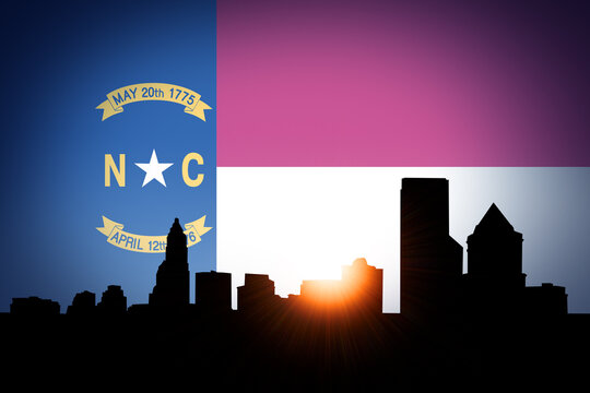 Charlotte Skyline at Sunrise with North Carolina Flag in Sky
