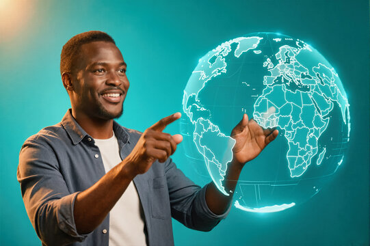 A smiling man pointing at a glowing holographic globe against a teal background. - Powered by Adobe