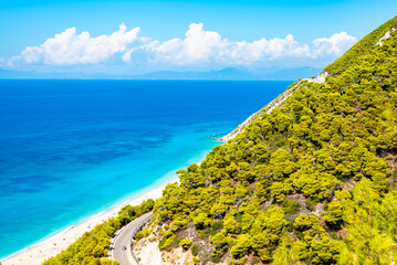 Road to amazing sea coast with pine trees on cliffs, Lefkada island, Greece
