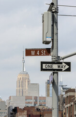 view of west 4th street (w 4 st) in manhattan with skycraper background view nyc new york city street scene one way sign signage travel greenwich village
