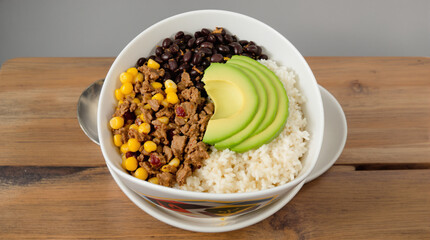 A vibrant and appetizing burrito bowl, showcasing a medley of fresh ingredients.
