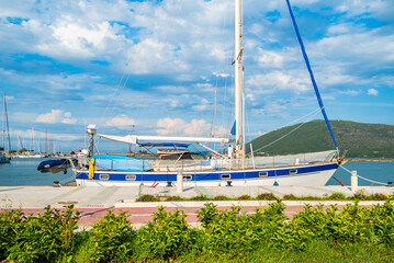 Sailboat on shore and view of Lefkada port, Lefkada island, Greece