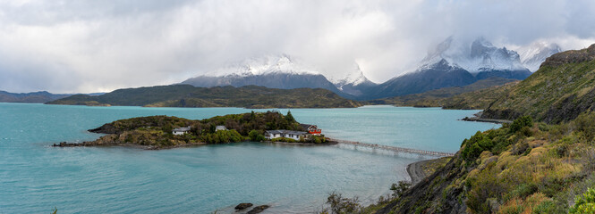 panoramic shot on an autumn morning of lake pehoe and hotel pehoe during a storm at torres del paine