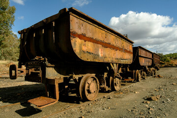 Naklejka premium Abandoned ore carts on rusted tracks at Rio Tinto Mine in Spain