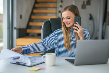 Woman multitasking working from home talking on phone